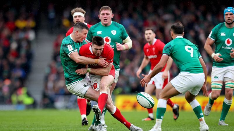 Ireland’s Johnny Sexton is recklessly tackled by Josh Adams of Wales, earning the Welsh player a yellow card. Photograph: Ryan Byrne/Inpho