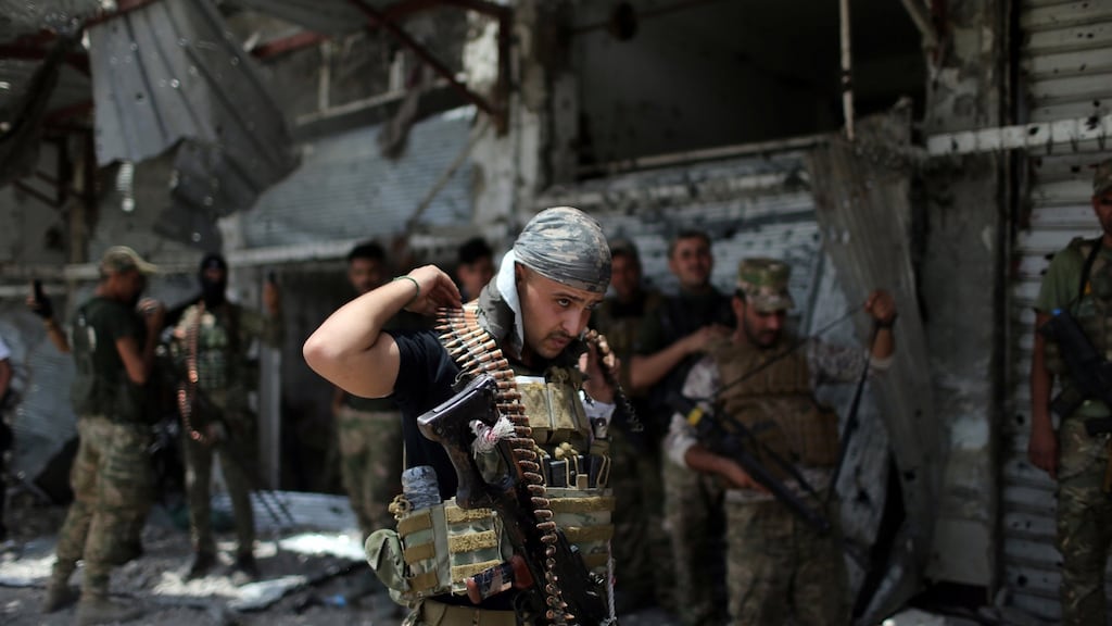A member of the Emergency Response Division carries his weapons during the fight with Islamic States militants in the Old City of Mosul. Photograph: Ahmed Jadallah/Reuters