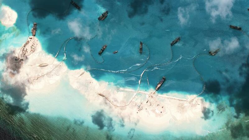 A satellite image shows Chinese dredgers at Mischief Reef, part of the Spratly Islands, in the South China Sea, last Month. There is evidence that China is aggressively building artificial reef in the area. Photograph: Asia Maritime Transparency Initiative/New York Times
