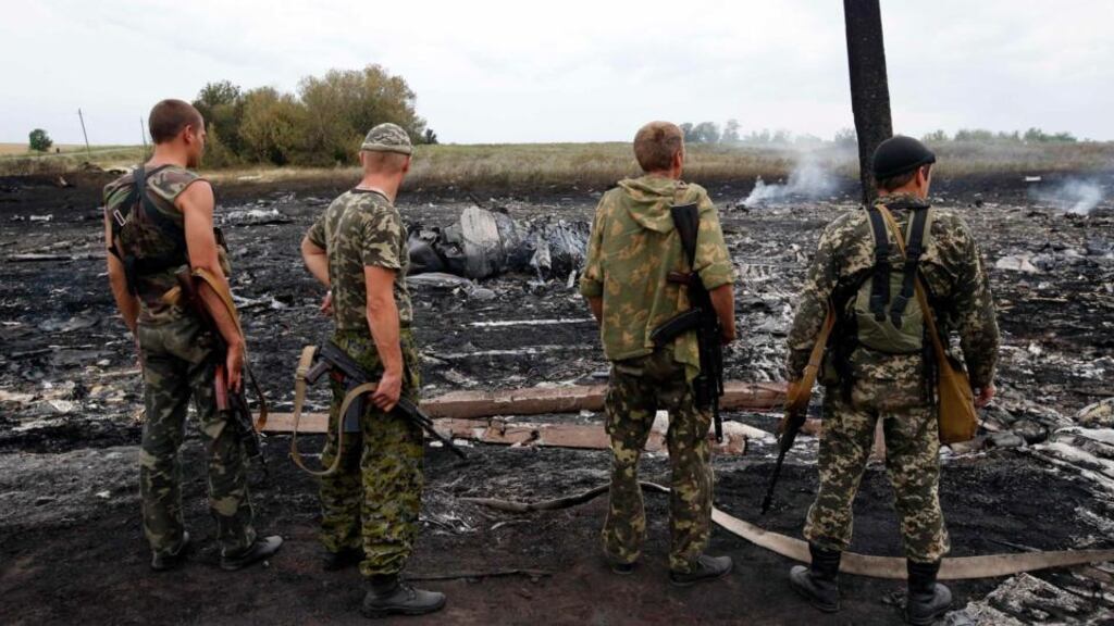 Pro-Russian separatists stand at the site of a Malaysia Airlines Boeing 777 crash near the settlement of Grabovo in the Donetsk region of Ukraine yesterday. Photograph: Maxim Zmeyev/Reuters