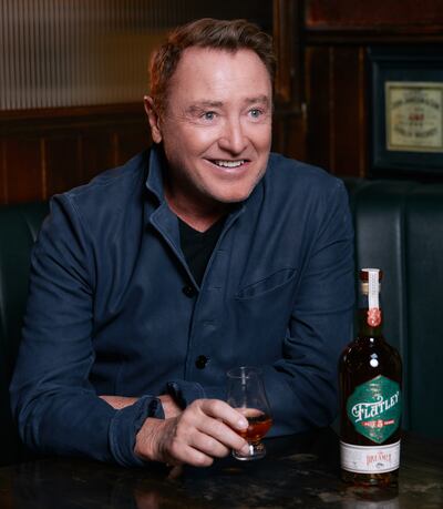 Michael Flatley with a bottle of his Flatley Irish Whiskey.