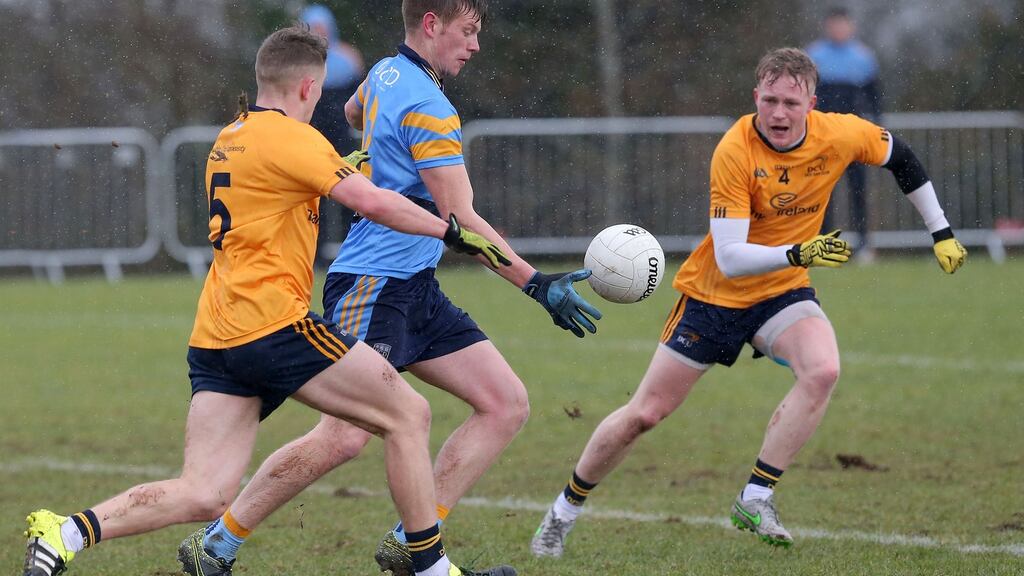 DCU’s Stephen Attride and Killian Daly with UCD’s John Heslin. Photograph: Declan Roughan/Inpho
