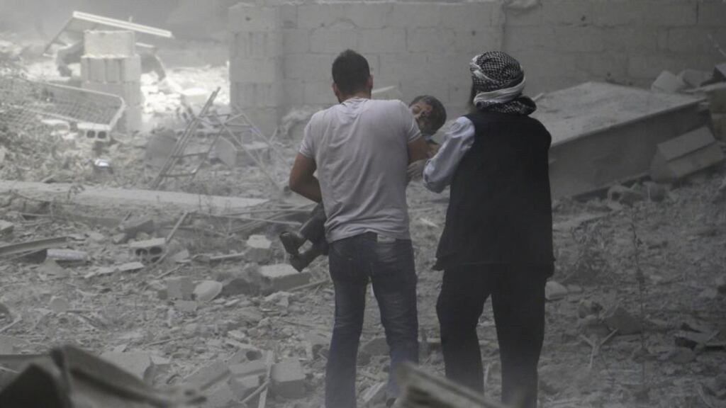 Men help an injured boy who survived what activists said were airstrikes by forces loyal to Syria’s president Bashar al-Assad, in the Douma neighborhood of Damascus in late August. Although international attention has turned to Islamic State atrocities, the country’s war has been far more destructive and deadly. Photograph: Bassam Khabieh/Reuters