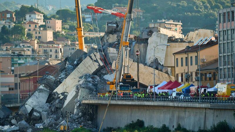 Rescuers search the crumbled hulk of the collapsed Morandi highway bridge in Genoa. Photograph: Luca Zennaro/ANSA via AP