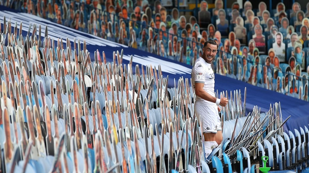 Leeds United’s Jack Harrison celebrates amongst the cardboard cutouts at Elland Road. Photograph: Martin Rickett/PA