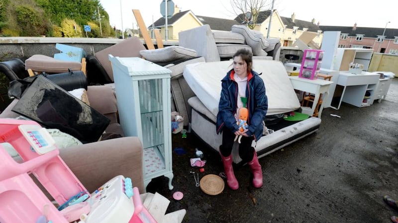 Ita Conroy surveys the water-damaged contents of her home near Manor Road in Mountmellick after it was inundated with floodwater on Wednesday. Photograph: Alan Betson/The Irish Times