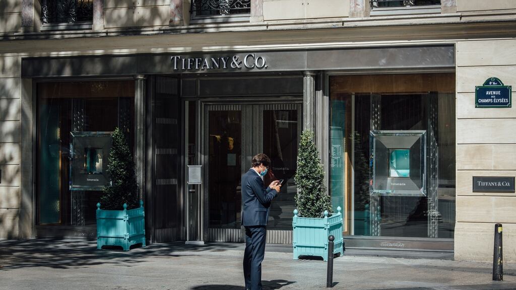 A pedestrian outside the Tiffany & Co. luxury jewelry store on Champs Elysee in Paris.