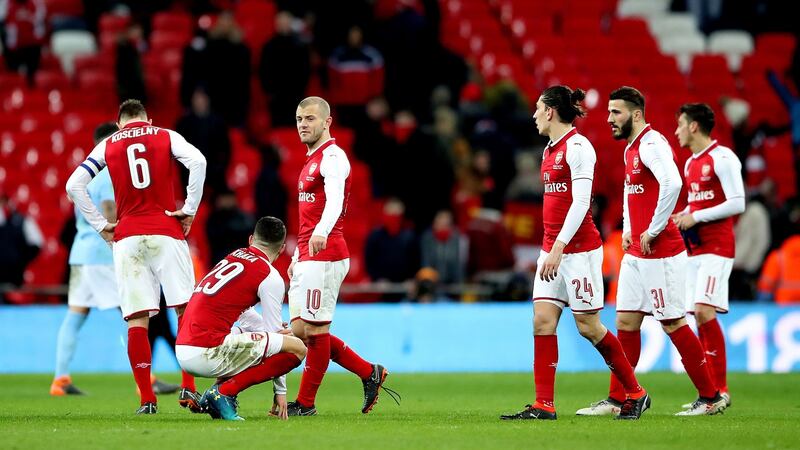 Arsenal players stand dejected at the end of the game. Photo: Nick Potts/PA Wire
