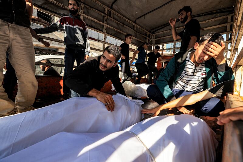 People with victims of the explosion at the Gaza hospital. Photograph: Mahmud Hams/AFP via Getty Images