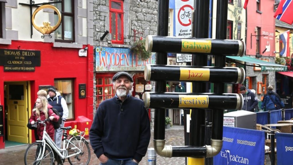 Tommy Lennon with his creation of a giant-size trumpet at Galway’s Cross Street yesterday. Photograph: Joe O’Shaughnessy