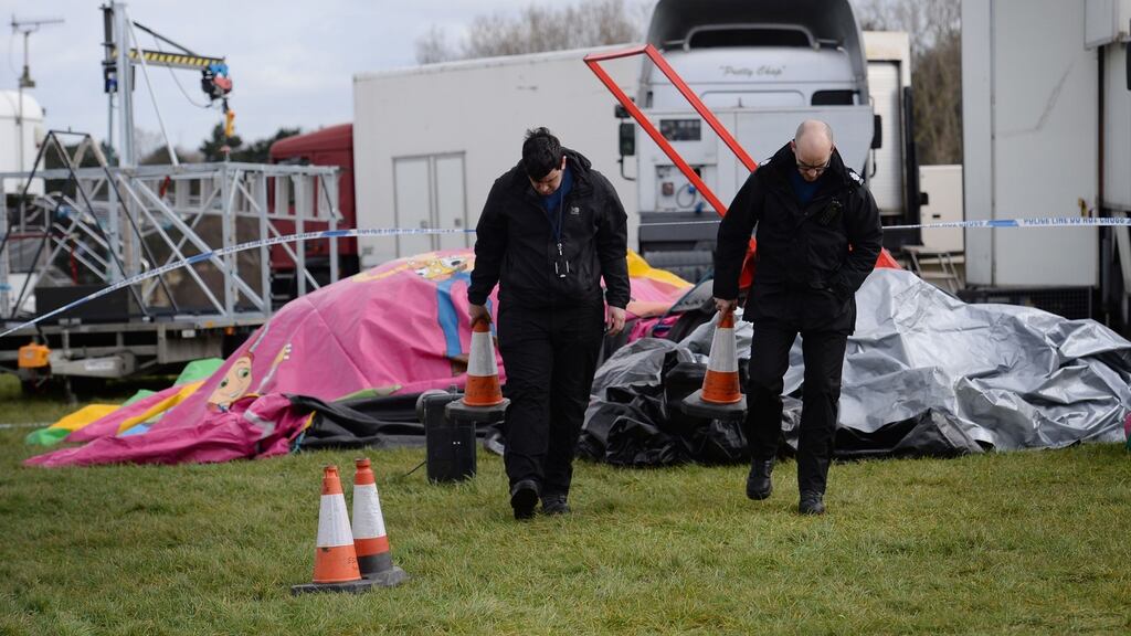 Forensic officers at the scene where a seven-year-old girl died after she was blown around 150 metres on a bouncy castle, which is thought to have been swept away by a sudden gust of wind at an Easter fair. Photograph: Stefan Rousseau/PA