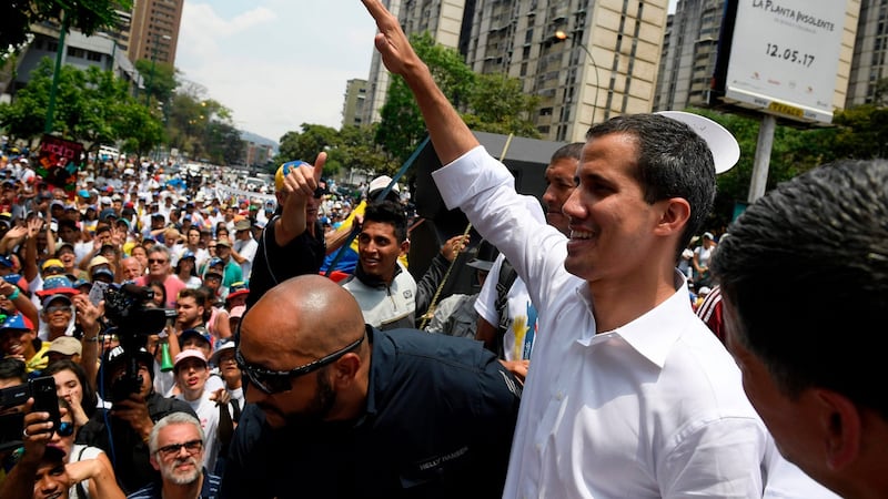 Venezuelan opposition leader Juan Guaidó gestures at supporters during a May Day rally. Photograph: Federico Parra/AFP/Getty Images