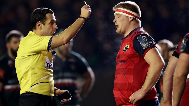 John Ryan receives a yellow card from referee Mathieu Raynal. Photo: Tommy Dickson /Inpho