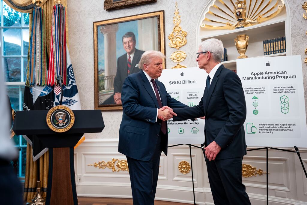 President Donald Trump shakes hands with Tim Cook, Apple’s chief executive, in the Oval Office of the White House on Wednesday. Cook pledged $100 billion more investment in the US by Apple. Photograph: Doug Mills/The New York Times
