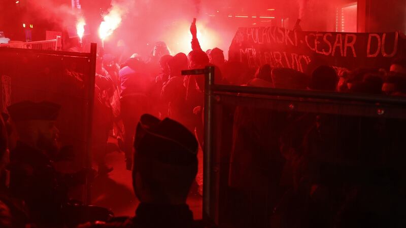 Members of the Colleuses Feministe collective waving a banner that reads ‘Polanski, Cesar of the Best Rapist 2020’. Photograph: AFP/Getty