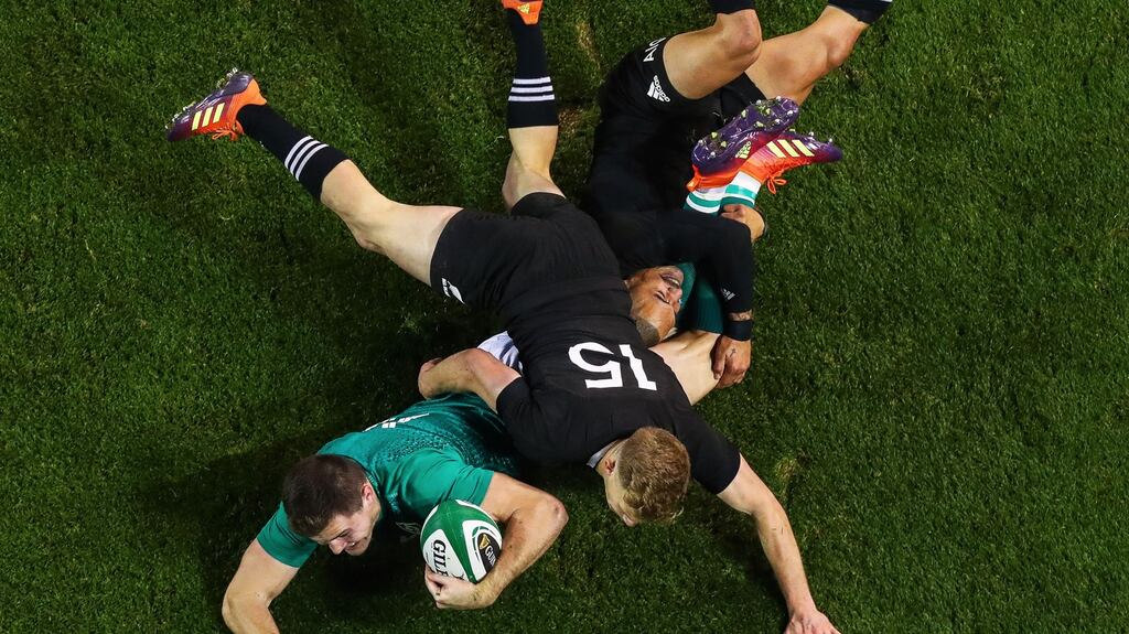 Ireland’s Jacob Stockdale scores a try despite the attempts of Damian McKenzie and Aaron Smith of New Zealand to stop him during the November international series at the Aviva stadium. Photograph: Tommy Dickson/Inpho