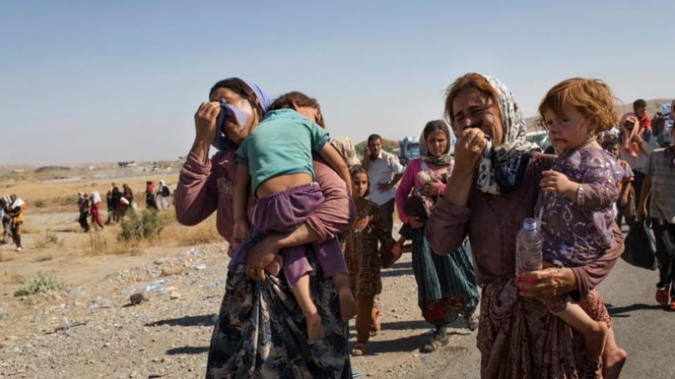 Iraqi Yazidi people who fled their homes in Sinjar enter Iraq from Syria at a border crossing in Feshkhabour in Dohuk province in August 2014. Thousands of members of the minority, fled their homes after Islamic State militants took control of Sinjar. Photograph: Adam Ferguson/The New York Times