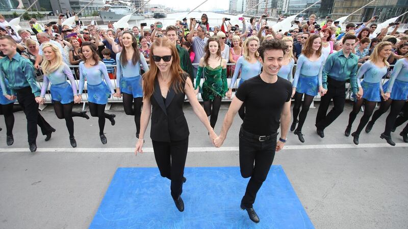 Jean Butler and Padraic Moyles lead the cast of Riverdance on Dublin’s  Samuel Beckett Bridge during the world record attempt for the longest line of Irish dancers. Photograph: Niall Carson/PA Wire