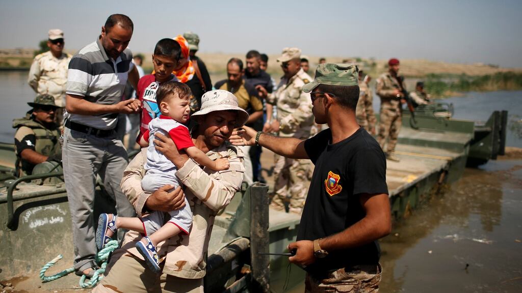 Displaced Iraqis cross the Tigris river by military boat after a bridge was temporarily closed, south of Mosul, Iraq on Thursday. Photograph: Suhaib Salem/Reuters