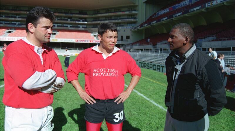 England’s Will Carling and Rory Underwood talk to Errol Tobias during a training session  in 1994. Photograph: David Rogers/Allsport