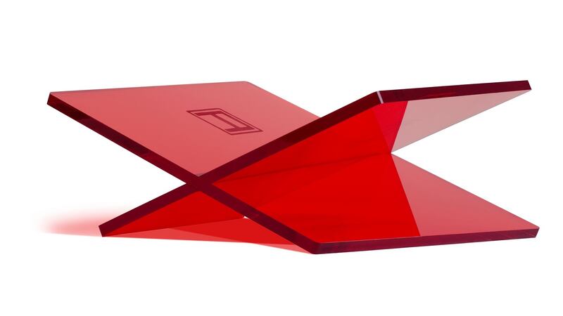 Assouline sells a very smart book stand that comes in red, black or clear acrylic.