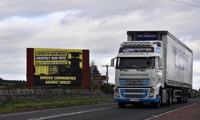 NEWRY, NORTHERN IRELAND - OCTOBER 09: A lorry crosses the border past a Border Communities Against Brexit billboard on October 9, 2018 in Newry, Northern Ireland. Talks on the Irish border are thought to be at a crucial stage as the EU and the UK attempt to resolve their differences over the backstop plan to avoid a hard border between the Republic of Ireland and Northern Ireland which is part of the United Kingdom. EU officials had expressed optimism at the weekend regards a Brexit deal being struck by the end of the year. (Photo by Charles McQuillan/Getty Images)