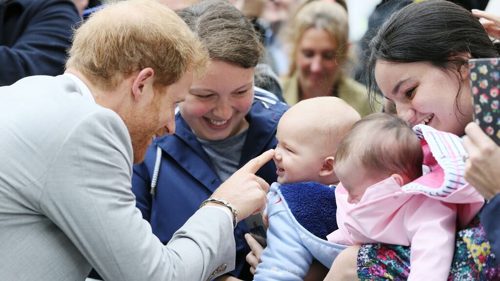 Prince Harry meets Emma Mason (second left) and her seven month old son Henry Mason in St Anne’s Square, Belfast, during his visit to Northern Ireland. Photograph: Brian Lawless/PA Wire