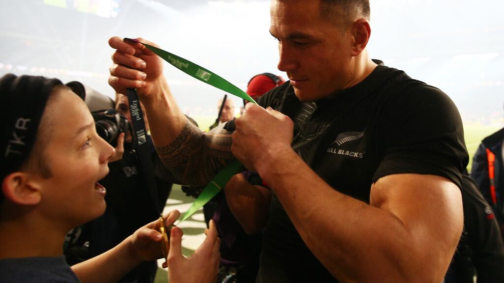 Sonny Bill Williams of New Zealand gives his winning medal to young fan Charlie Lines following the 2015 Rugby World Cup Final between New Zealand and Australia at Twickenham Stadium in London. Photo: Paul Gilham/Getty Images