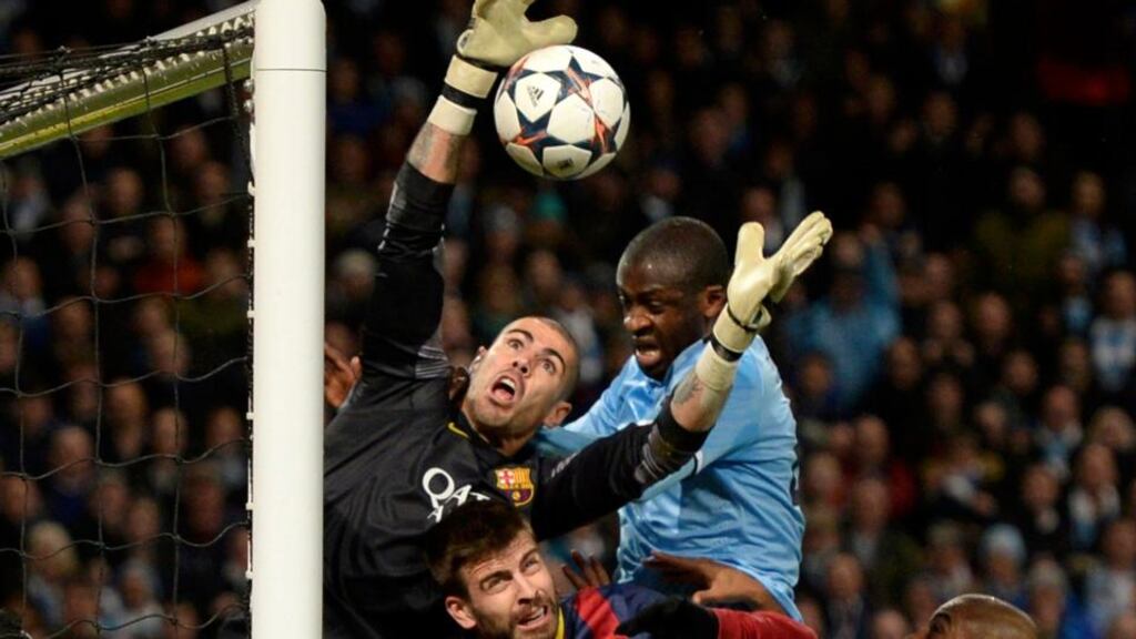 Manchester City’s Yaya Toure (centre) tries to score past Barcelona’s goalkeeper Victor Valdes (left) during the Champions League round of 16 first leg match at the Etihad Stadium in Manchester. Photograph: Nigel Roddis/Reuters