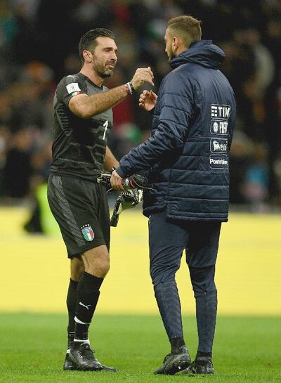 A dejected Buffon embraces and Gianluigi Donnarumma after the play-off with Sweden. Photograph: Getty Images