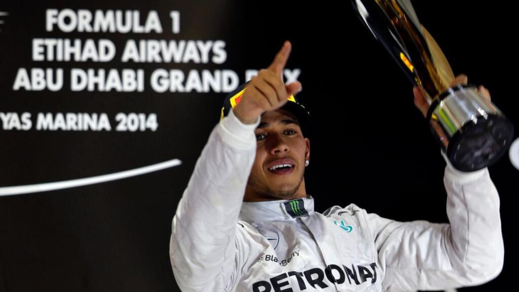 Mercedes Formula One driver Lewis Hamilton of Britain celebrates on the podium after winning the Abu Dhabi F1 Grand Prix and the F1 Championship at the Yas Marina circuit in Abu Dhabi. Photograph: Ahmed Jadallah / Reuters