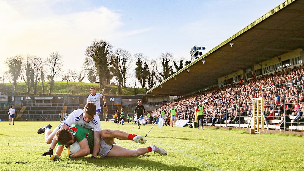 Mayo’s Oisin Mullin is tackled by Shane Carey of Monaghan during the Allianz Division One clash in Clones. Photo: Tommy Dickson/Inpho