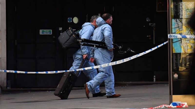 Forensics officers make their way near London Bridge in central London. Photograph: Ben Stansall/AFP via Getty