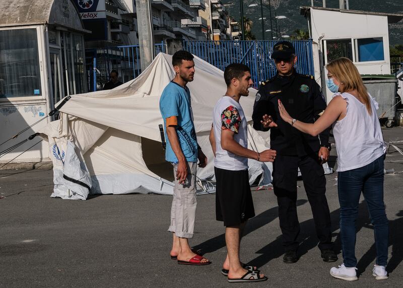 Migrants who survived the sinking of the Adriana outside a hangar with Greek coast guard authorities in Kalamata, Greece. Photograph: Byron Smith/Getty Images