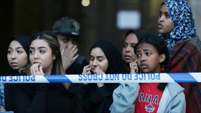Local residents watch as Grenfell Tower is engulfed by fire in west London. Photograph: Daniel Leal-Olivias/AFP/Getty Images