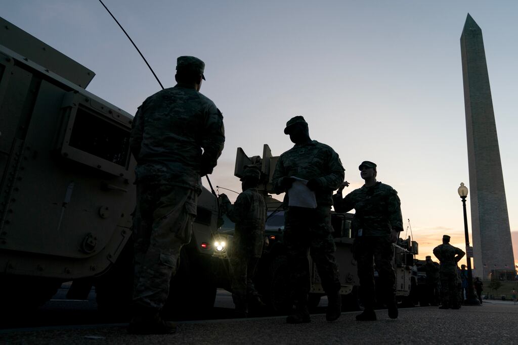 Members of the US national guard and armored vehicles near the Washington Monument in Washington DC on Tuesday night. Photograph: Stefani Reynolds/Bloomberg