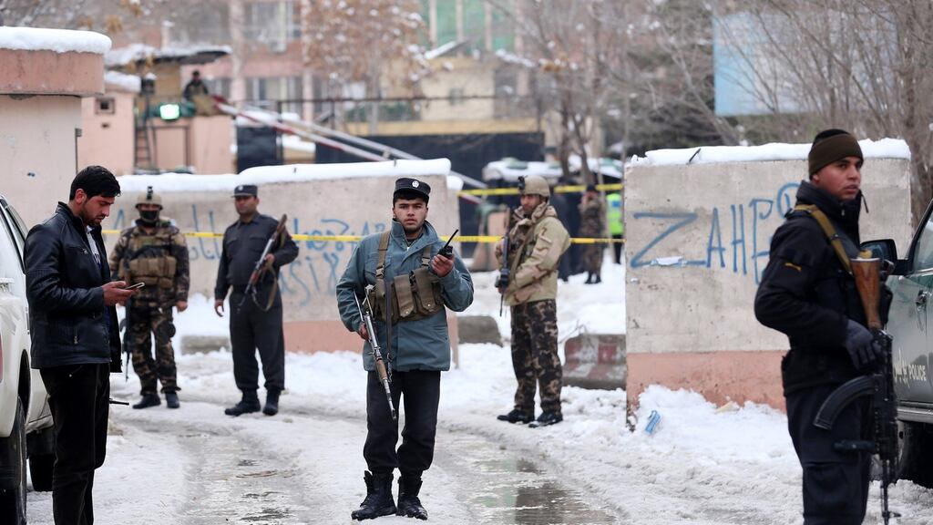 Afghan security officials stand guard outside the Afghan supreme court building after a suicide bomb blast in Kabul, Afghanistan. Photograph: Hedayatullah Amid/EPA