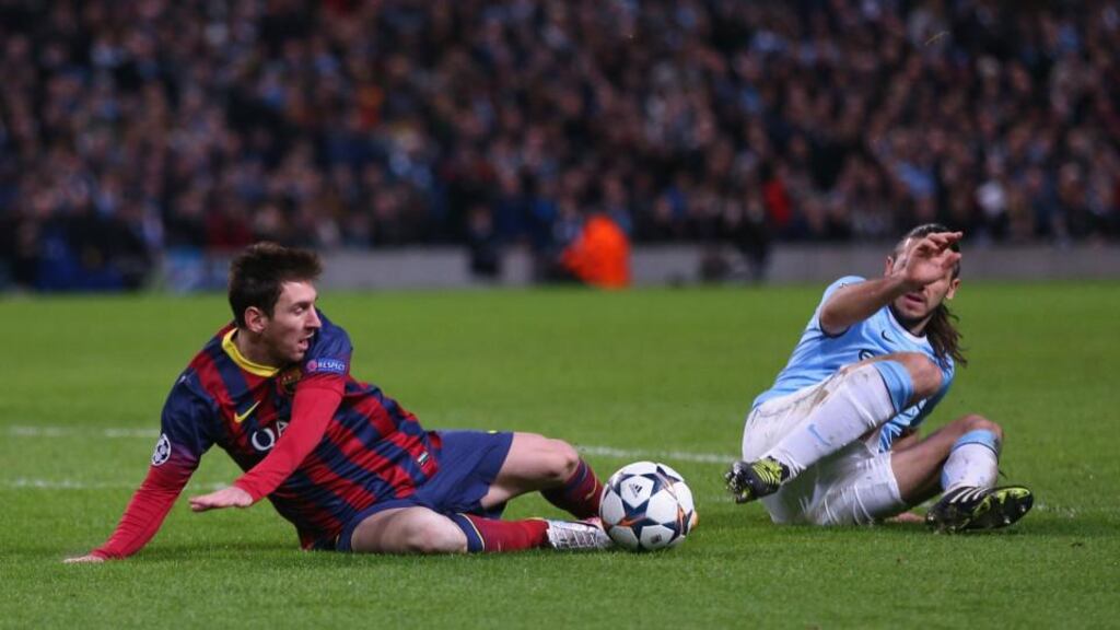 Martin Demichelis brings down Lionel Messi to concede a penalty and earn a red card. Photograph: Clive Brunskill/Getty Images