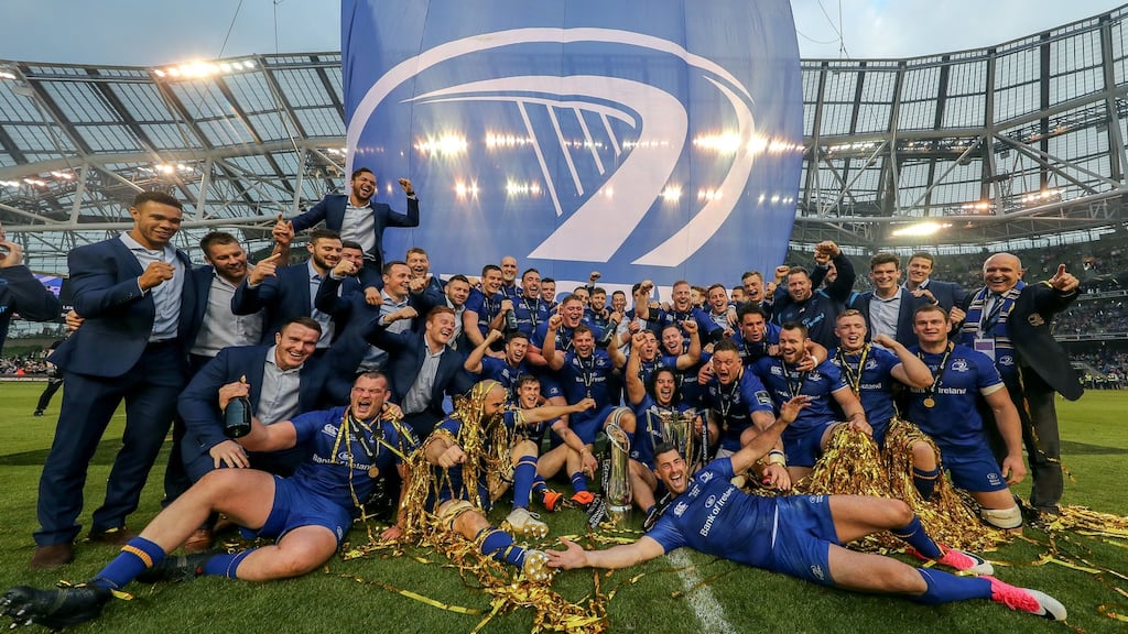 Leinster players celebrate with the Pro14 and Champions Cup trophies. Photo: Billy Stickland/Inpho