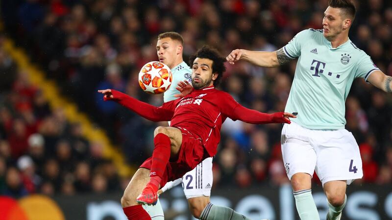 Liverpool’s Mohamed Salah  battles with Joshua Kimmich and Niklas Suele of Bayern Munich  during the Champions League round of 16 first leg at Anfield. Photograph:  Clive Brunskill/Getty Images