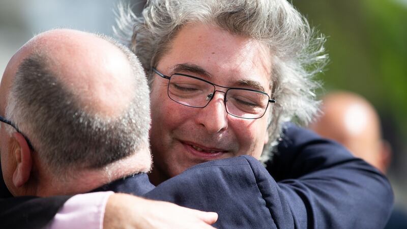 Jan Kaminski’s son Jas is comforted at his father’s  funeral. Photograph: Tom Honan / THE IRISH TIMES