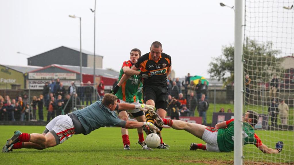 Austin Stacks’ Kieran Donaghy squeezes the ball into the Mid Kerry net during yesterday’s county final. Photograph: Inpho