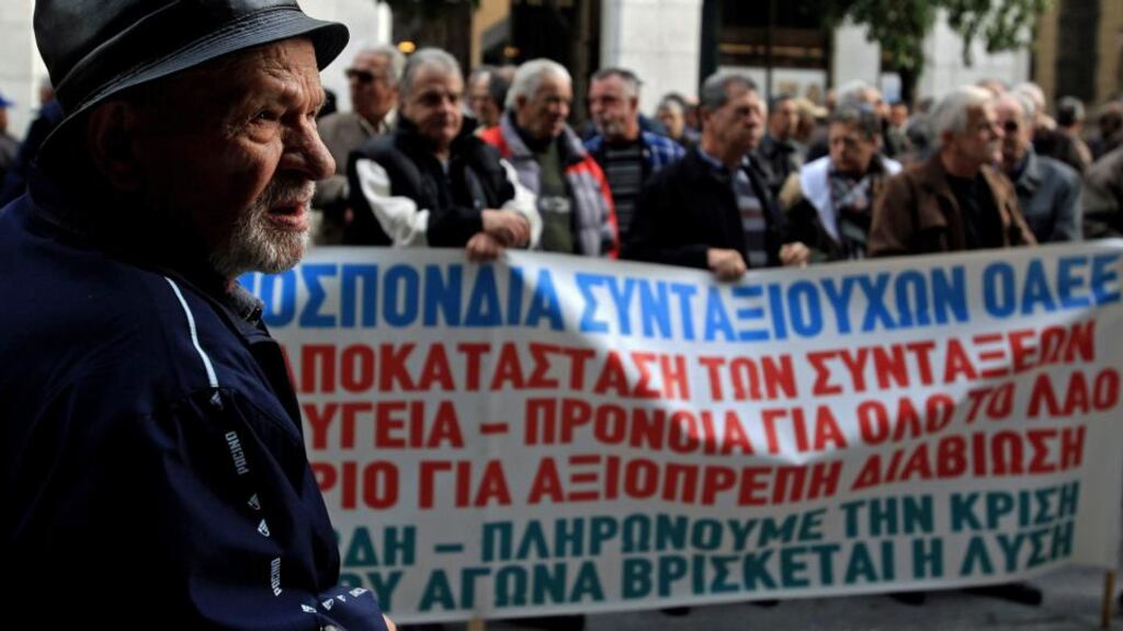 Pensioners hold a banner during a rally demanding their pension bonuses back outside the labour ministry in Athens. Photograph: Simela Pantzartzi/EPA