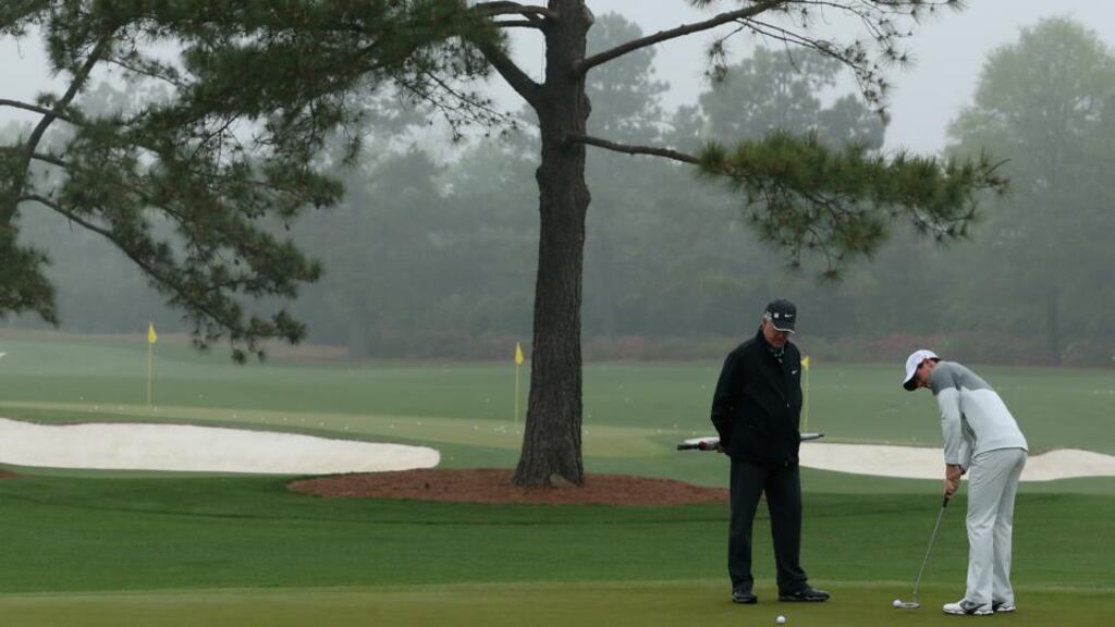 Rory McIlroy  practices putting as his coach Dave Stockton looks on  at Augusta National Golf Club . Photograph: Andrew Redington/Getty Images