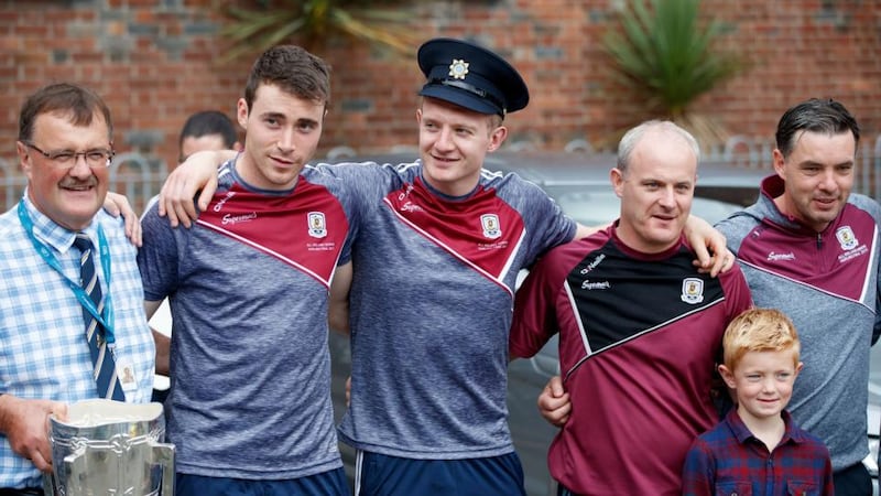 All-Ireland champions: the Galway players Conor Cooney and Joe Canning and manager Micheál Donoghue at Our Lady’s Children’s Hospital, in Crumlin. Photograph: Bryan Keane/Inpho