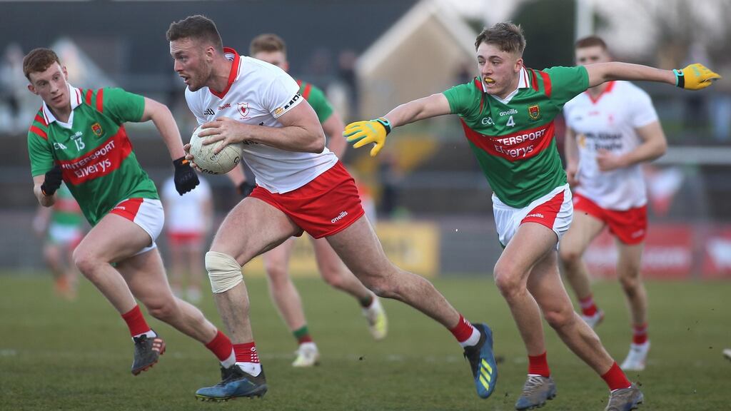Tyrone’s Brian Kennedy powers past Mayo’s Aiden Orme and Donnacha McHugh. Photograph: Lorcan Doherty/Inpho