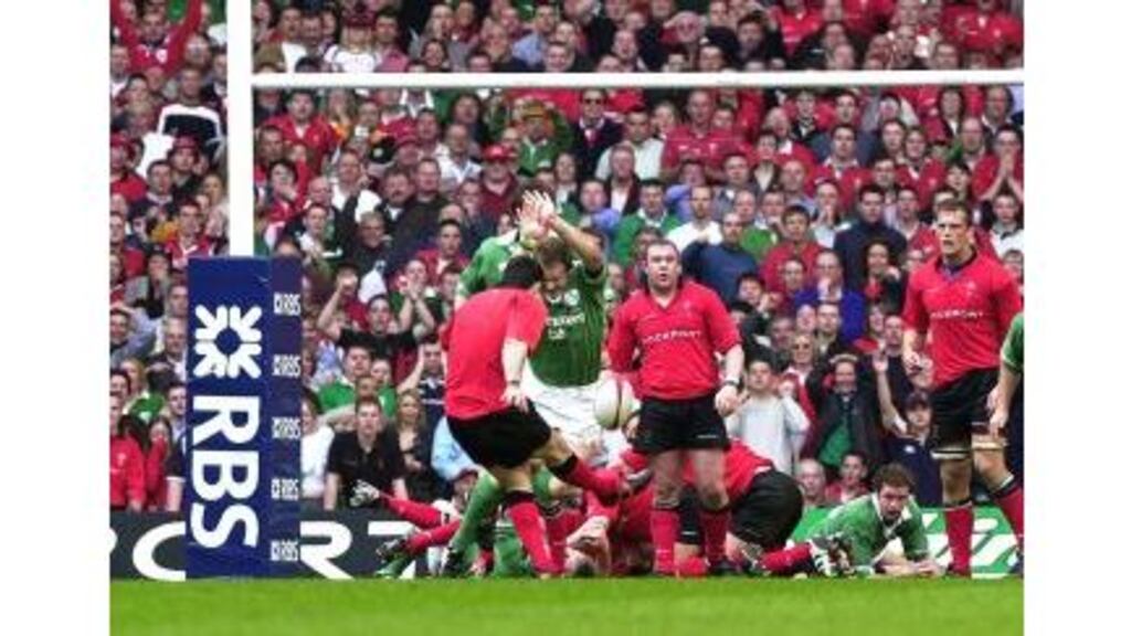 Ireland's Denis Hickie charges down a last-minute drop-goal in last year's Six Nations match against Wales.