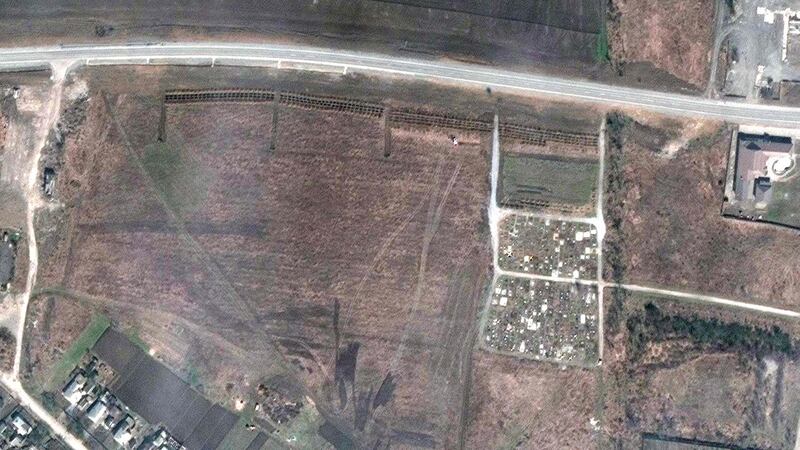 A satellite overview on April 21st of an alleged mass grave site adjacent to an existing village cemetery on the northwestern edge of Manhush, outside Mariupol. Photograph: Maxar Technologies/AFP via Getty