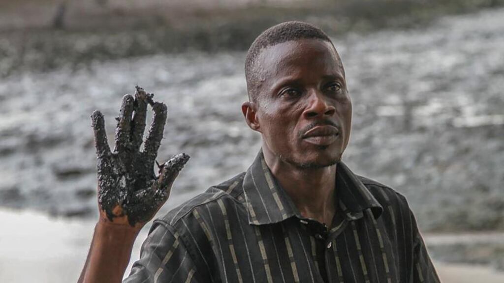Eric Barizah of the Goi community in Rivers State, Nigeria, shows oil pollution from leaks in the Niger Delta, Nigeria, in 2013. Photograph: EPA