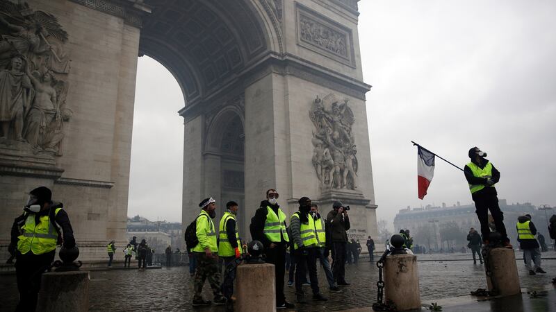 Protesters wearing yellow vests occupy the Place de l’Etoile at the foot of the Arc de Triomphe, as they clash with riot police. Photograph: EPA
